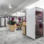 Hushphone Single office telephone booth with ergonomic armrest and glass paneling