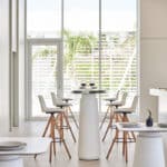 Dorik Cafe Table in a modern café and collaborative workspace with round tabletop and pedestal base