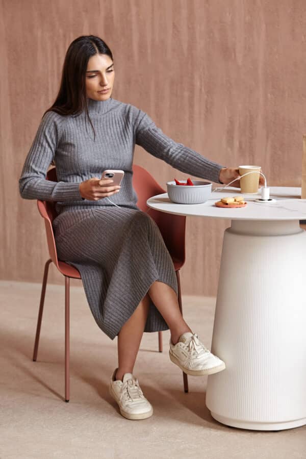Dorik Cafe Table in a contemporary café setting with a round tabletop and pedestal base